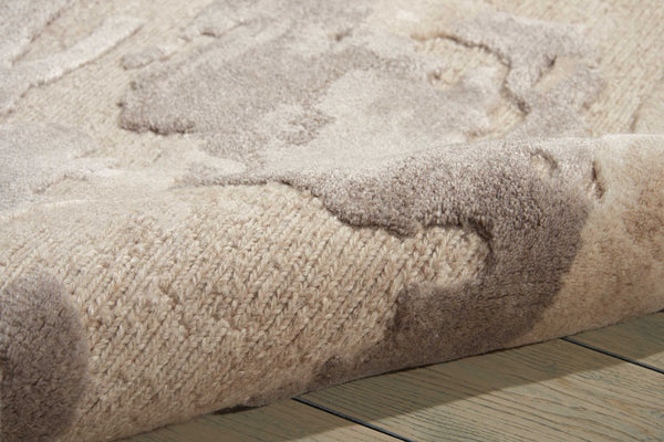 Close-up of plush, textured area rug with varied beige pattern.