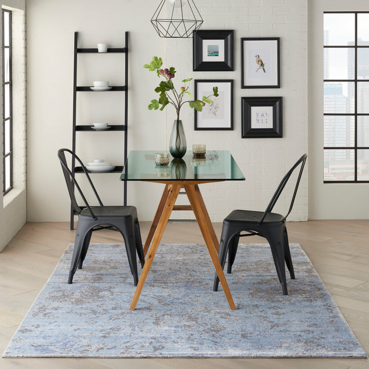 Contemporary dining area with urban view, featuring unique wooden table.