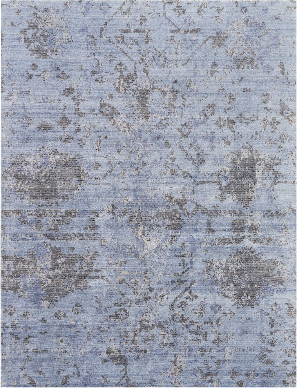 Vintage-inspired distressed blue carpet with intricate floral motifs.