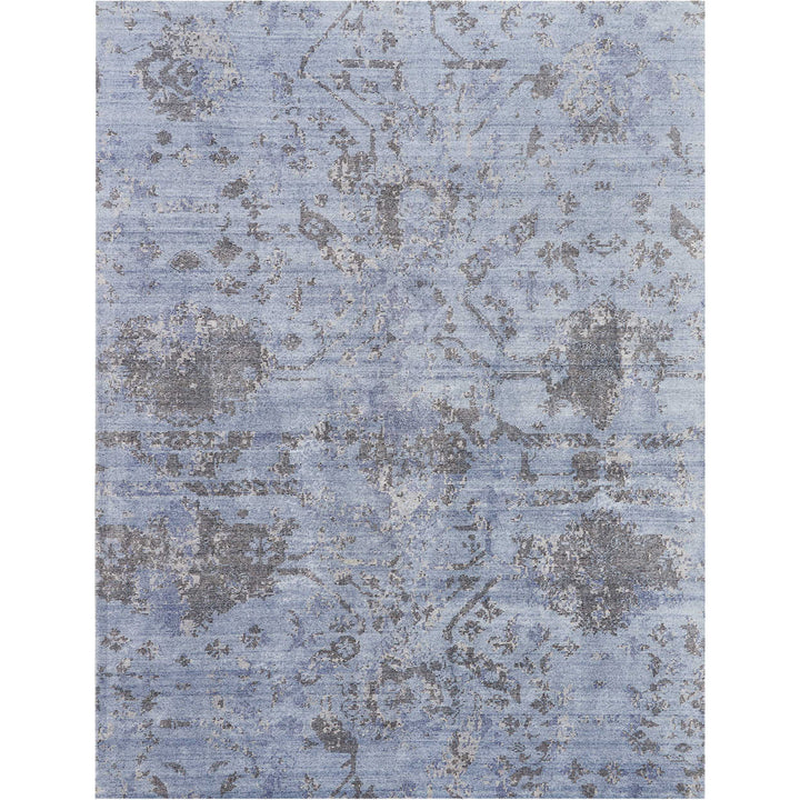 Vintage blue carpet with faded ornamental design for classic interiors.