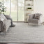 Contemporary living room with a large textured gray area rug.