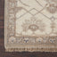 Intricate traditional woven rug with geometrical shapes and floral motifs.