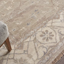 Close-up of a sophisticated area rug with intricate patterns and fringe.