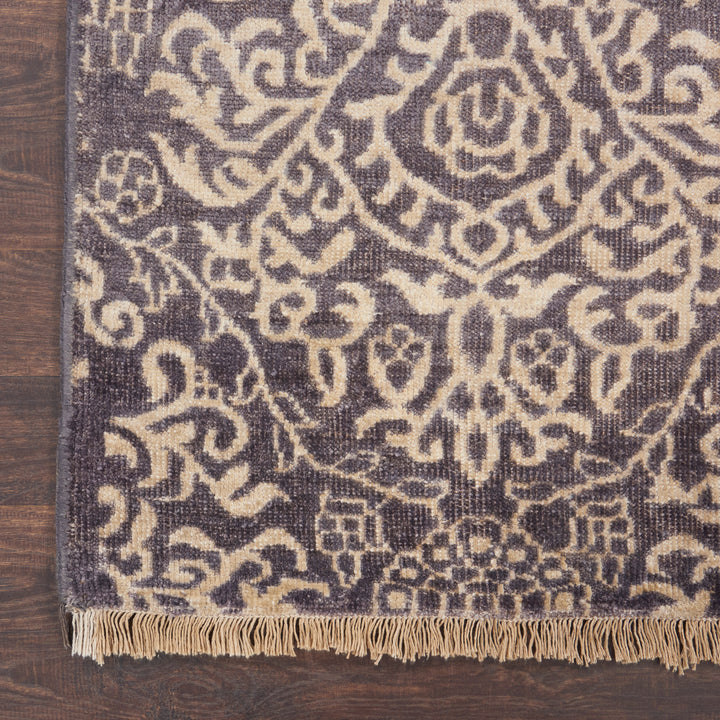 Intricately patterned rug with fringed edges adds elegance to interiors.