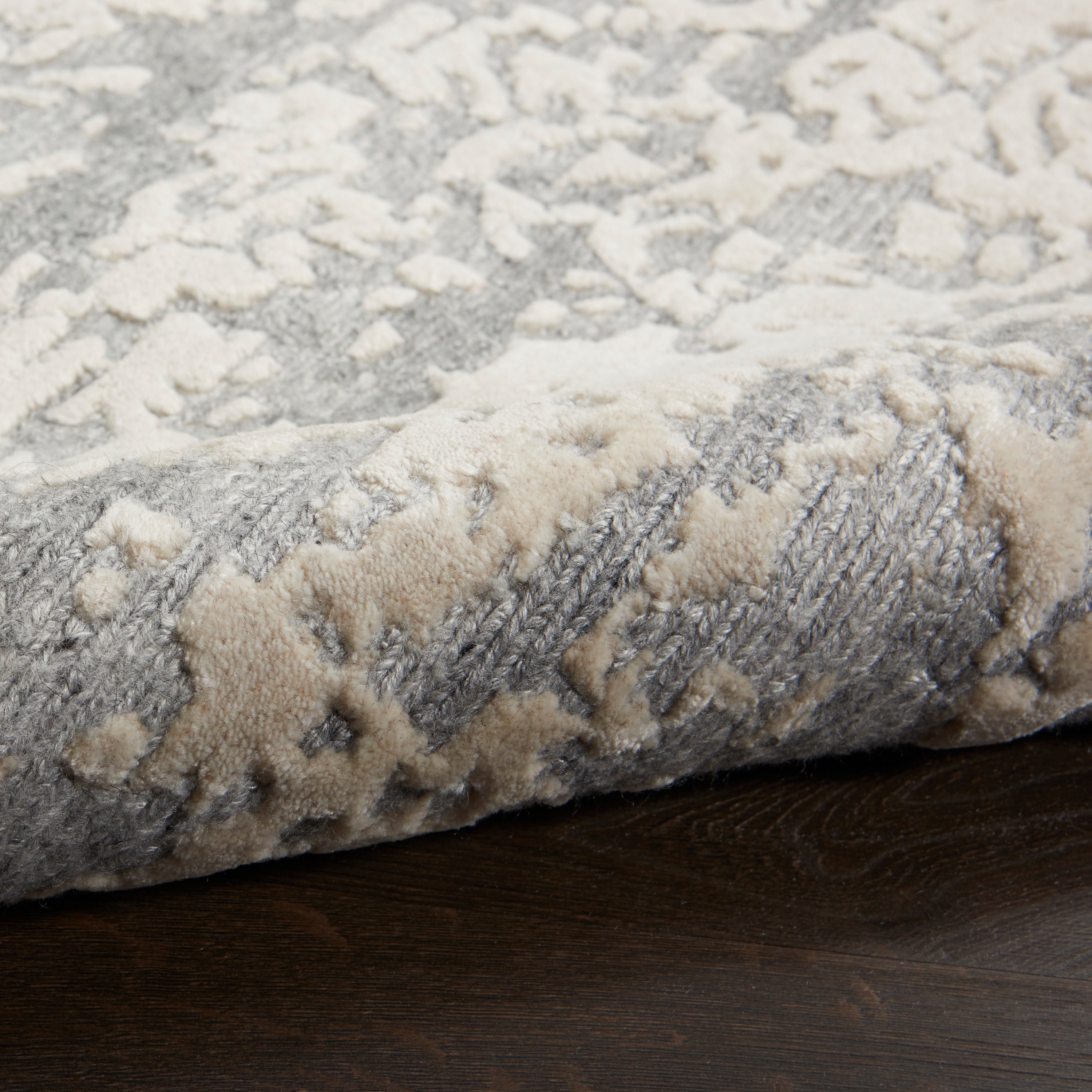 Close-up of a plush area rug with a folded corner.