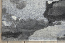 Close-up view of a marbled rug with abstract gray design.
