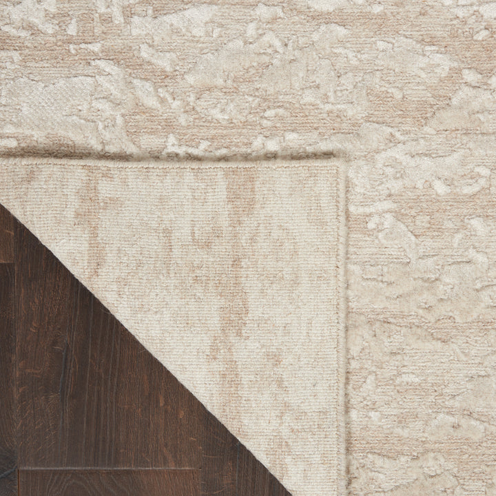 Close-up view of a decorative rug on hardwood floor, revealing texture.