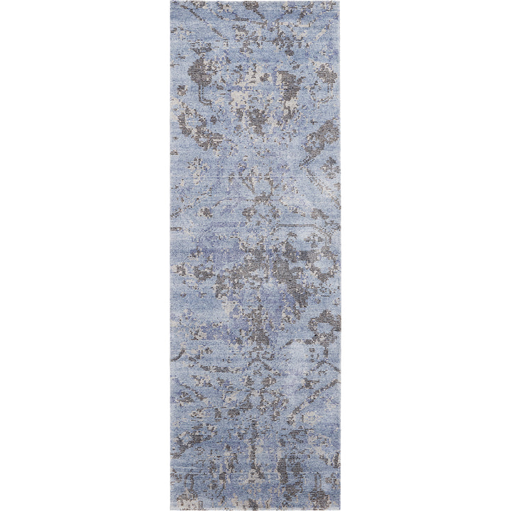 Vintage-inspired blue area rug with abstract distressed design.