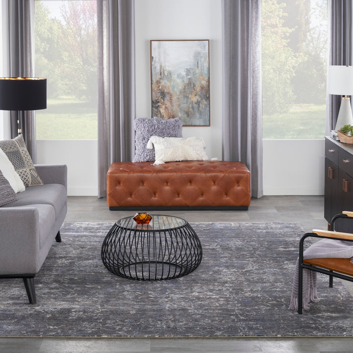 Contemporary living room with stylish furniture and serene landscape artwork.