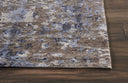 Close-up of textured area rug with abstract, distressed pattern.