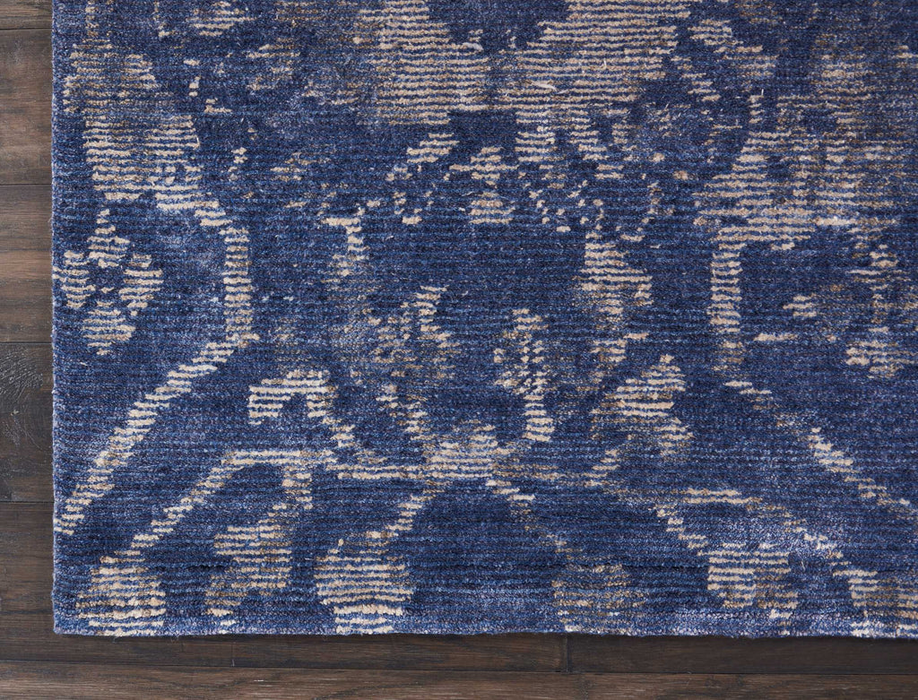 Close-up of a textured area rug with blue and off-white pattern