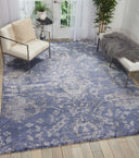 Elegant and cozy room featuring a blue floral rug centerpiece