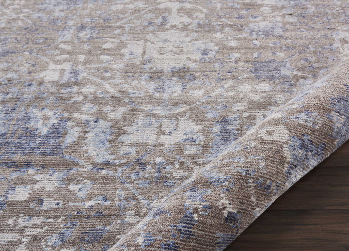 Close-up of distressed vintage-style rug on hardwood floor