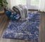 Serene and stylish room with an ornate rug and cozy chair.