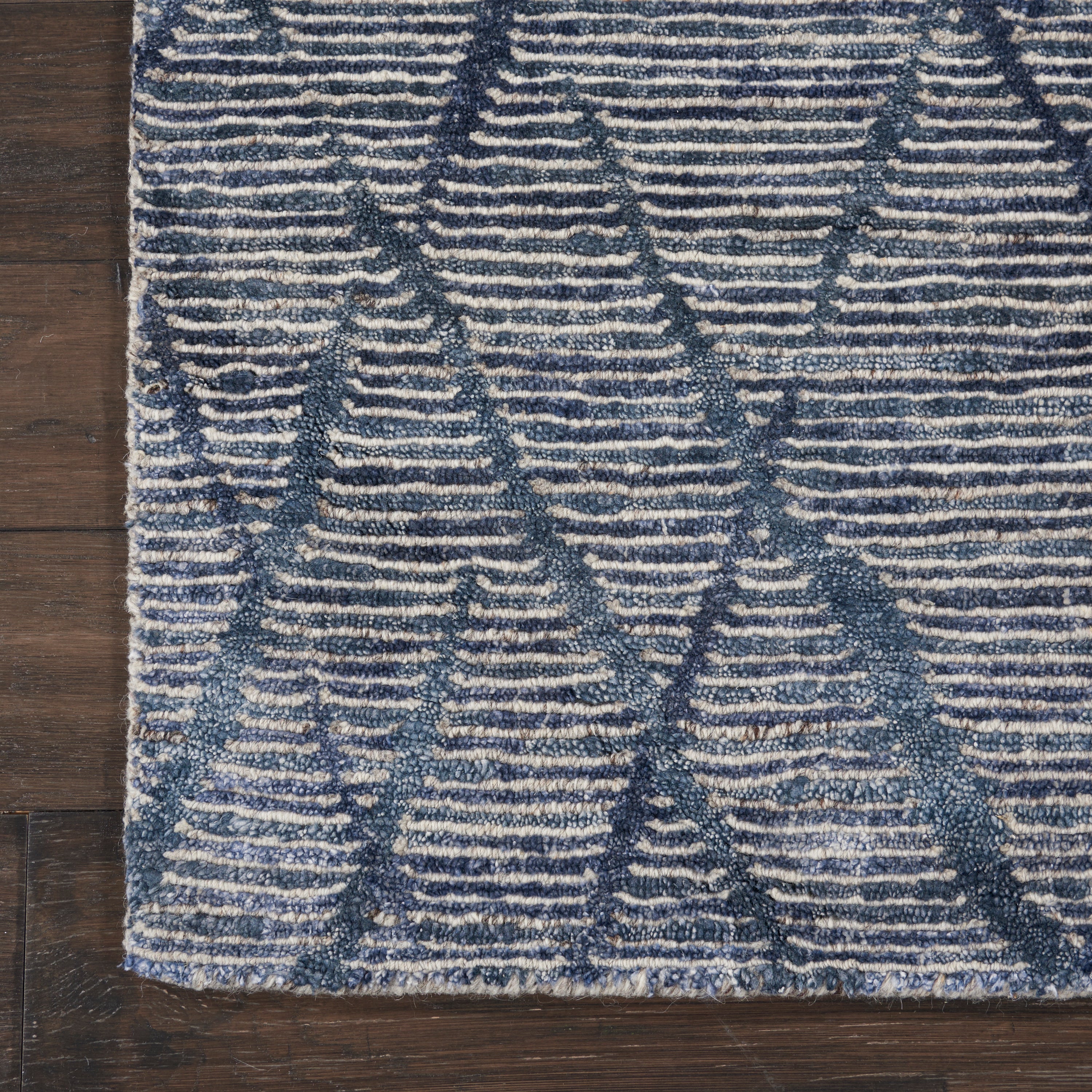 Close-up of a textured rug with diamond pattern in blue