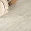 Close-up view of textured floor covering with fringe edge and woven basket, creating a warm and cozy domestic space.