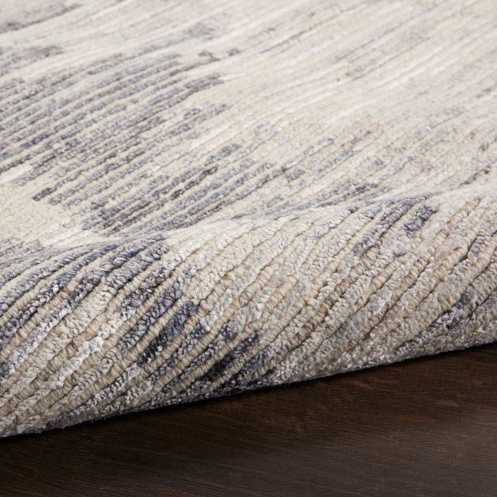 Close-up of a folded rug with a cozy, textured pattern.