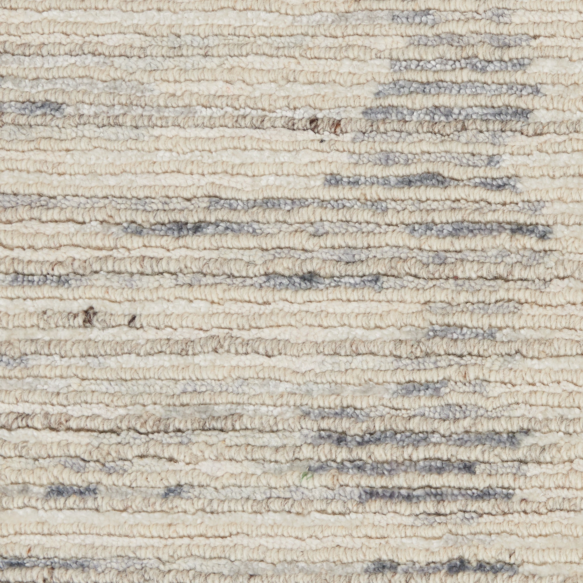 Close-up of textured, undyed fabric with horizontal blue stripes.