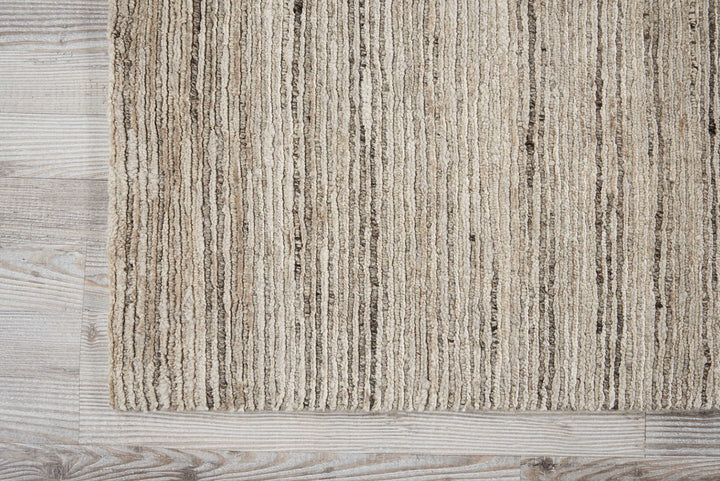 Textured rug with ribbed pattern on rustic wooden floor