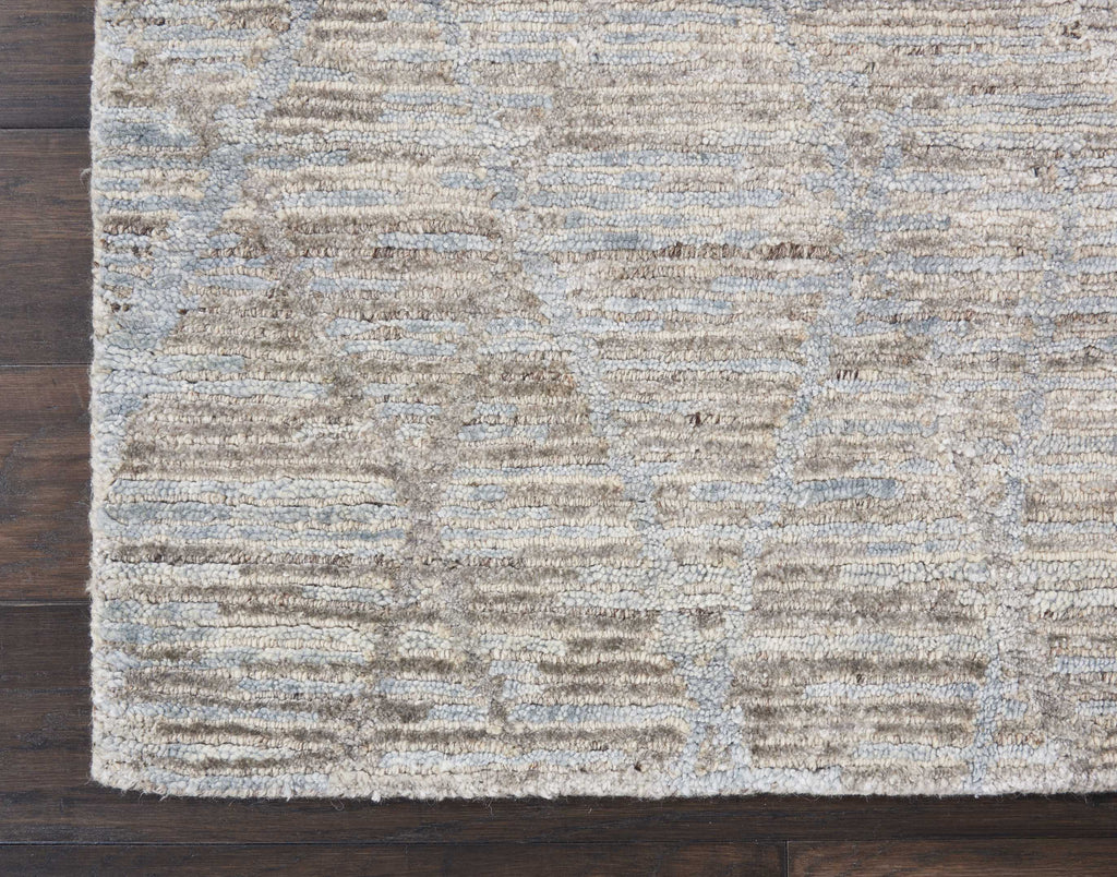 Textured rug with alternating stripes enhances neutral, cozy flooring.