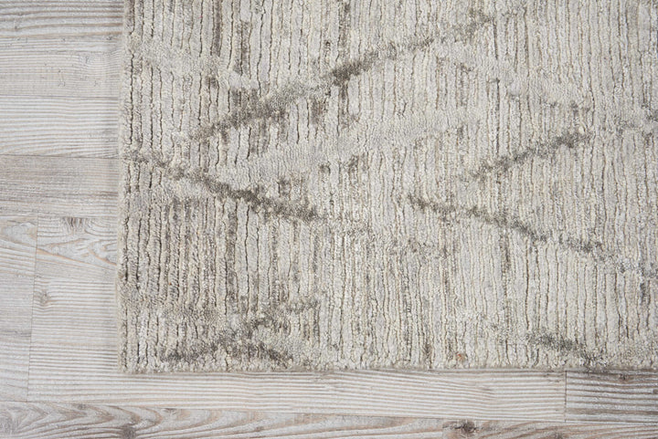 Neutral-toned carpet with subtle pattern complements rustic wooden flooring.