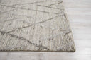 Textured rug with plush pile and linear pattern on wooden floor.