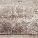 Abstract mauve rug on hardwood floor adds modern aesthetic.
