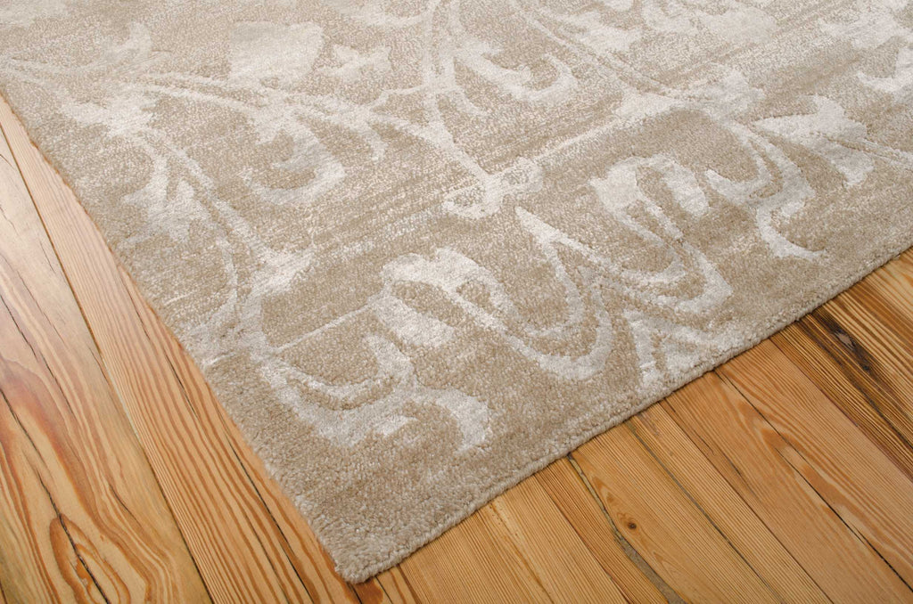 Beige, ornately patterned rug adds elegance and texture to room.