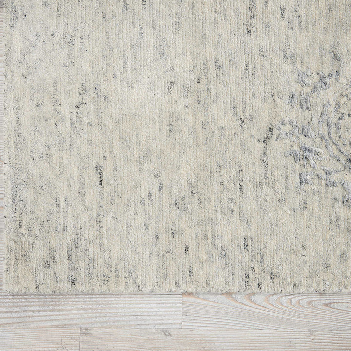 Textured rug with vintage flair complements rustic wooden flooring.