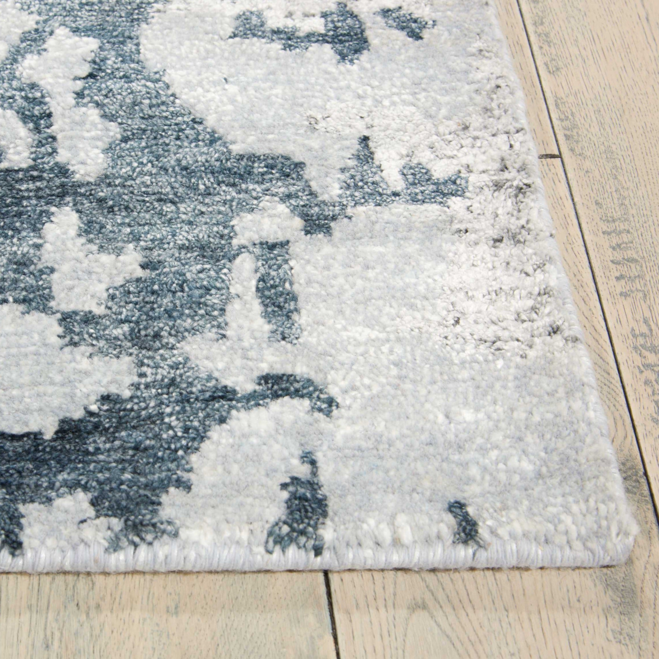 A close-up view of a plush blue and white patterned rug.