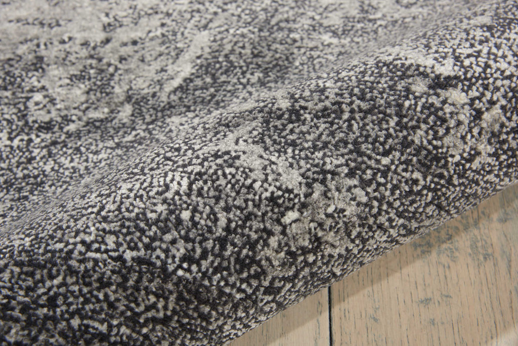 Close-up of plush, textured gray carpet showcasing its luxurious comfort.