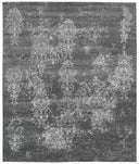 Vintage gray rug with ornamental patterns in worn, elegant design.