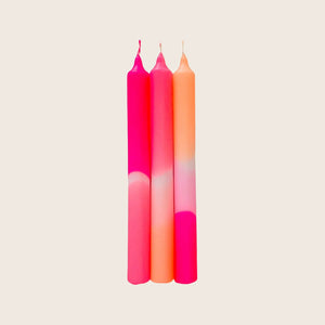 Tall slender candles with ombre effect in pink to peach.
