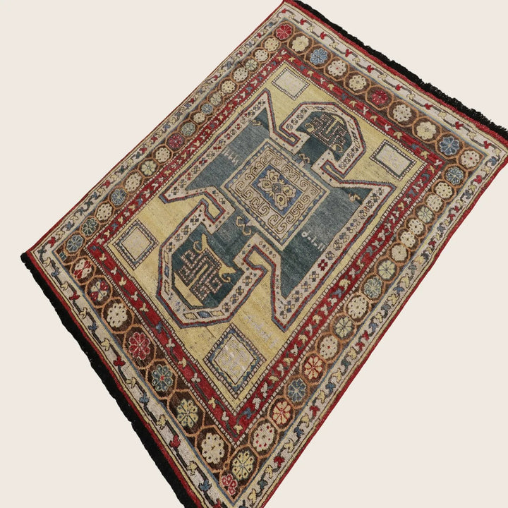 Intricately designed oriental rug featuring geometric and floral patterns.
