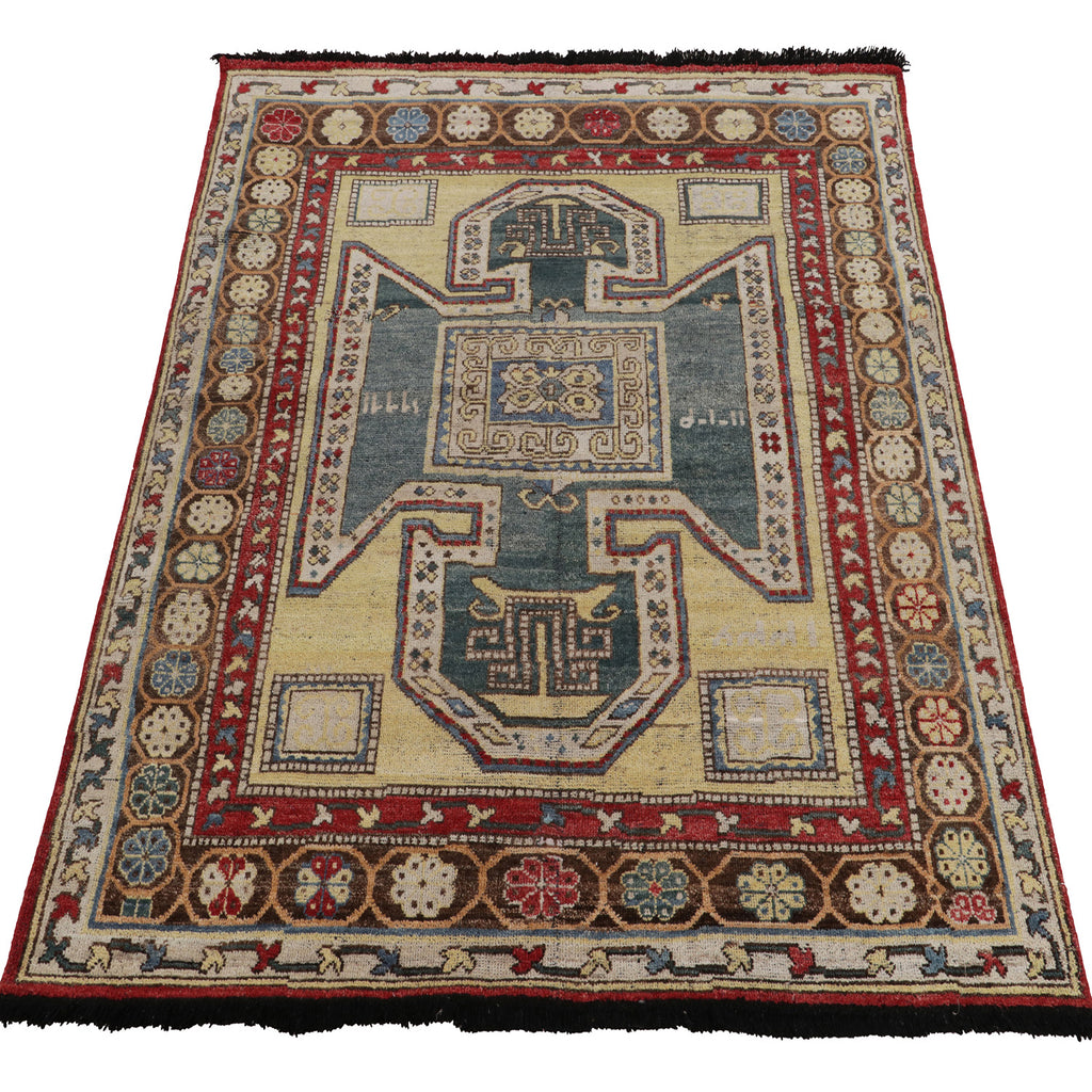 Antique, handwoven rug with intricate geometric design and earth tone palette.