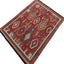 Exquisite oriental rug with intricate patterns in rich red tone.