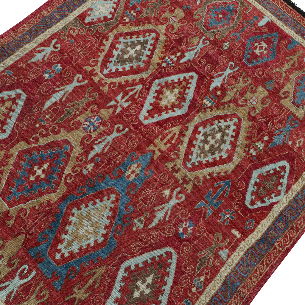 Intricate, symmetrical rug with diamond and floral motifs in rich colors.