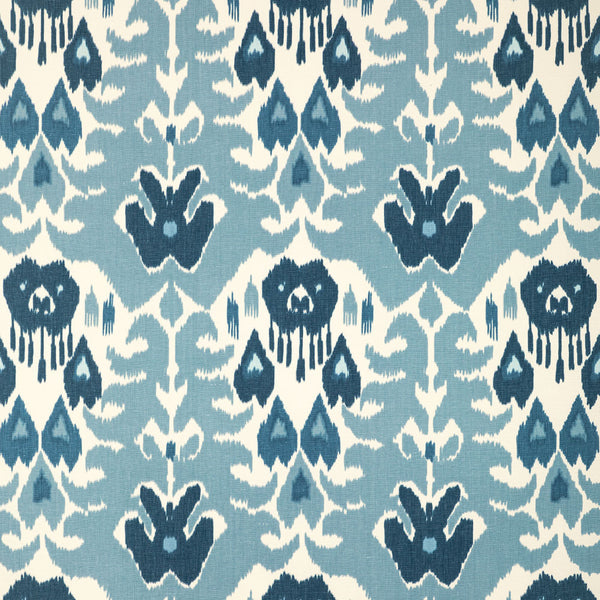 Symmetrical, ikat-style fabric pattern in shades of blue and off-white.