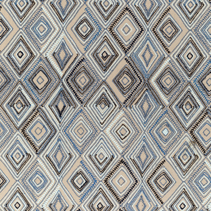 Complex and detailed geometric diamond pattern with beige, blue, and black shades.