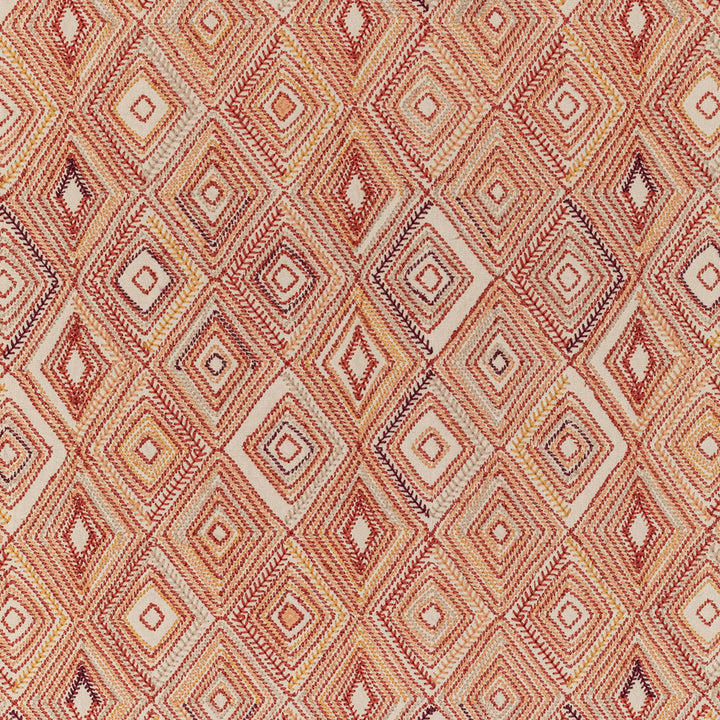 Intricate geometric textile design featuring repeating diamond shapes in warm tones.