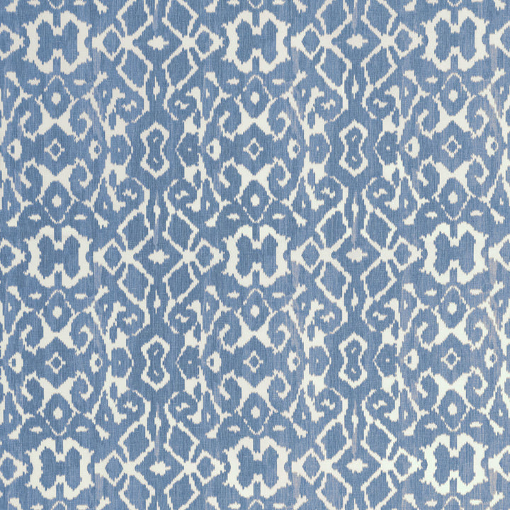 Symmetrical repeating pattern on blue textile with geometric shapes.