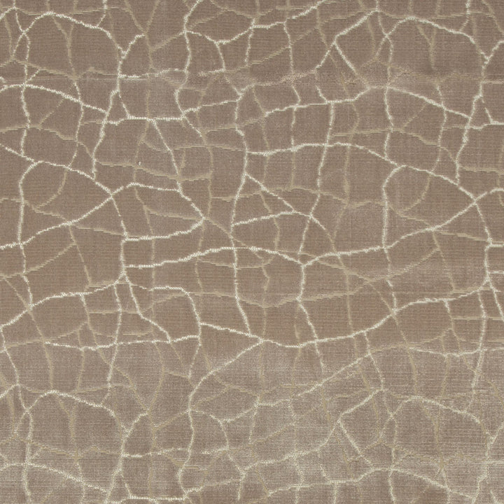 Close-up of textured fabric with cracked earth-like mosaic pattern.