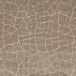 Close-up of textured fabric with cracked earth-like mosaic pattern.