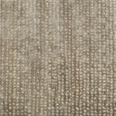 Close-up of textured fabric with repeated vertical lines and dots.