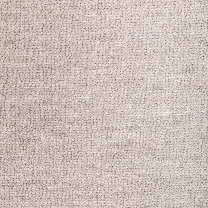 Close-up photo of a beige carpet with uniform looped piles.
