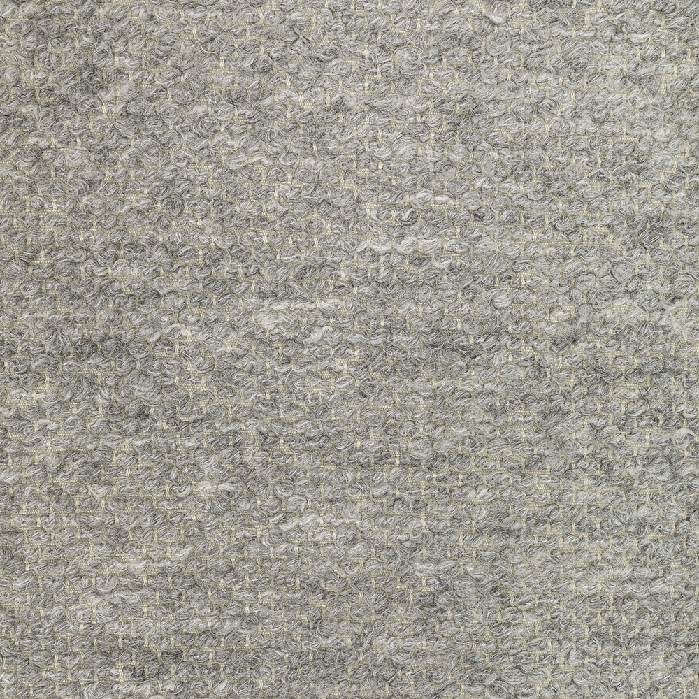Close-up of high-pile, grey fabric texture with dense loops.