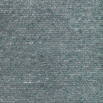 Close-up of textured fabric with looped pile and mottled effect.