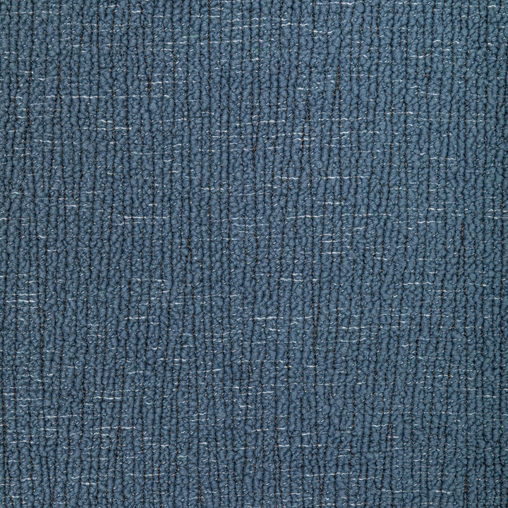 Close-up of blue twill fabric, resembling denim, with worn effect.