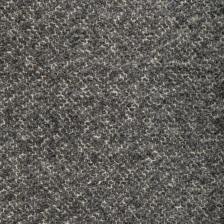 Close-up of a looped pile fabric or carpet with intricate pattern.