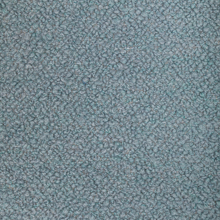 Close-up view of a densely looped textured fabric in bluish tones.